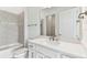 Bathroom featuring vanity with sink, and a shower-tub combo with gray tile at 11517 Waterway Dr, Parrish, FL 34219