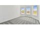 Bright bedroom with gray carpet and two windows offering lots of natural light at 11517 Waterway Dr, Parrish, FL 34219