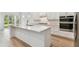 Modern kitchen showcasing a large island, stainless steel appliances, and ample cabinet space at 11517 Waterway Dr, Parrish, FL 34219