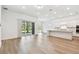 Open concept living space featuring wood floors and sliding glass doors at 11517 Waterway Dr, Parrish, FL 34219