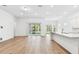 Bright, open-concept space with wood floors, large windows, and seamless flow to the kitchen at 11517 Waterway Dr, Parrish, FL 34219