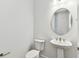 A stylish powder room with a pedestal sink and modern fixtures at 11517 Waterway Dr, Parrish, FL 34219