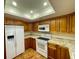 Modern kitchen with white appliances and wood cabinets at 2671 Sabal Springs Cir # 102, Clearwater, FL 33761