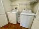 Laundry room with white washer and dryer and wire shelving at 2671 Sabal Springs Cir # 102, Clearwater, FL 33761