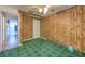 Bedroom with wood paneling and green carpeting at 36919 Chancey Rd, Zephyrhills, FL 33541