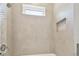 Clean bathroom with beige tile, shower, and small window at 3829 71St N St, St Petersburg, FL 33709