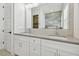Modern bathroom with double vanity, gray countertops and a large mirror at 3829 71St N St, St Petersburg, FL 33709