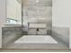 Elegant bathroom featuring a soaking tub and stylish gray tile at 3829 71St N St, St Petersburg, FL 33709