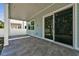 Covered patio with grey tile flooring and sliding glass door at 3829 71St N St, St Petersburg, FL 33709