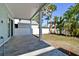 Covered patio with grey tile flooring and backyard access at 3829 71St N St, St Petersburg, FL 33709