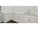Modern wet bar with white cabinets and a stainless steel sink at 3829 71St N St, St Petersburg, FL 33709