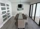 Bright dining room with a rustic wood table and modern lighting at 3963 Glen Oaks Manor Dr, Sarasota, FL 34232