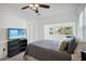 Main bedroom with gray bedding, TV, and access to private patio at 56 W Park St, Tarpon Springs, FL 34689