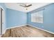 Bedroom with light blue walls and wood flooring at 5938 Sweet Birch Dr, Riverview, FL 33578