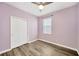 Lavender bedroom with wood-look floors and ceiling fan at 5938 Sweet Birch Dr, Riverview, FL 33578