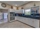 Well-equipped kitchen featuring granite countertops and ample cabinetry at 6650 Sunset Way # 207, St Pete Beach, FL 33706