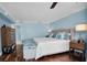 Main bedroom with king-size bed, hardwood floors, and ample natural light at 6650 Sunset Way # 207, St Pete Beach, FL 33706