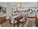 Bright dining room with hardwood floors and elegant chandelier at 6650 Sunset Way # 207, St Pete Beach, FL 33706