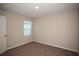 Simple bedroom with neutral walls and carpeted floor at 7727 Peace Lily Ave, Wesley Chapel, FL 33545