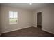 Well-lit bedroom with window, closet, and neutral decor at 7727 Peace Lily Ave, Wesley Chapel, FL 33545