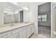 Bright bathroom featuring a double sink vanity and a glass-enclosed shower at 9450 Shorebird Ct, Parrish, FL 34219