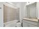 Neutral-toned bathroom featuring a shower-tub combo, toilet, and vanity with good lighting at 9450 Shorebird Ct, Parrish, FL 34219