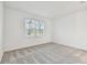 Cozy bedroom with a large window, neutral carpet, and bright light at 9450 Shorebird Ct, Parrish, FL 34219