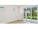 Bright bedroom with windows and a sliding glass door to the lanai at 9450 Shorebird Ct, Parrish, FL 34219