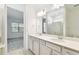 Bathroom features a double vanity, framed mirror, and adjacent door to the bedroom at 9454 Shorebird Ct, Parrish, FL 34219
