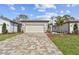 Charming home featuring a paver driveway, a two-car garage, and well-maintained landscaping at 9454 Shorebird Ct, Parrish, FL 34219