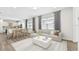 Bright living room featuring modern furnishings and a large window with beautiful natural light at 9454 Shorebird Ct, Parrish, FL 34219