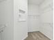 A walk-in closet is equipped with wire shelving and storage, carpet flooring at 9454 Shorebird Ct, Parrish, FL 34219