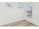 Bright bedroom featuring wood-look floors and windows at 9462 Shorebird Ct, Parrish, FL 34219