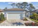 Charming single-Gathering home with a brick driveway and a two-car garage at 9462 Shorebird Ct, Parrish, FL 34219