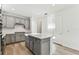Bright kitchen with a center island, gray cabinets, and modern stainless appliances at 9462 Shorebird Ct, Parrish, FL 34219