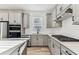 Well-equipped kitchen with gas range, stainless steel appliances, and light wood floors at 9462 Shorebird Ct, Parrish, FL 34219
