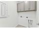 Laundry room with upper cabinets, and hookups at 9462 Shorebird Ct, Parrish, FL 34219