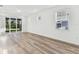 Bright and airy living room with large windows, light wood floors, and neutral walls at 9462 Shorebird Ct, Parrish, FL 34219