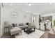 Bright, open-concept living room with a modern sectional sofa and gray tones at 9462 Shorebird Ct, Parrish, FL 34219
