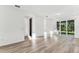 Spacious living area with sliding glass doors to the backyard and light wood flooring at 9462 Shorebird Ct, Parrish, FL 34219