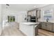 Spacious open floor plan showcases light wood floors with kitchen and sliding glass doors at 9462 Shorebird Ct, Parrish, FL 34219