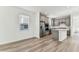 Open-concept living space with light wood flooring, kitchen, and ample natural light at 9462 Shorebird Ct, Parrish, FL 34219