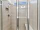 Walk-in shower with glass door, niche, rainfall showerhead and bench at 9462 Shorebird Ct, Parrish, FL 34219