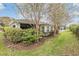 Landscaped backyard with lush greenery and screened patio at 10230 Old Tampa Bay Dr, San Antonio, FL 33576