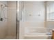 Bathroom with shower and tub, light wood vanity at 10230 Old Tampa Bay Dr, San Antonio, FL 33576