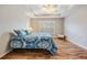 Spacious bedroom with wood floors and a large window at 10230 Old Tampa Bay Dr, San Antonio, FL 33576