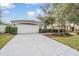 House exterior features a two-car garage and well-manicured landscaping at 10230 Old Tampa Bay Dr, San Antonio, FL 33576