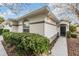 House exterior showcases a walkway to the front door and neatly trimmed bushes at 10230 Old Tampa Bay Dr, San Antonio, FL 33576