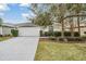 House exterior with a two car garage and landscaped yard at 10230 Old Tampa Bay Dr, San Antonio, FL 33576