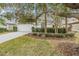 Landscaped front yard with mature trees and a driveway at 10230 Old Tampa Bay Dr, San Antonio, FL 33576